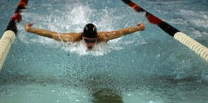 Thomas Lankiewicz ('12) swims the 100m butterfly event on Saturday at the Obermiller Pool. - Paul Kramer
