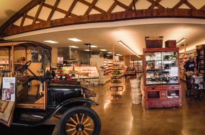 The new interior of McNally's features antique trusses and a vintage Model-T, reflecting the original 1920s Ford dealership it now inhabits.