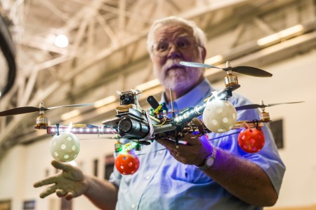 Automation expert Thomas Kaminski shows Grinnellians a model drone in the Bear Recreation Center.  Photo by John Brady
