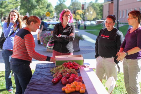 Students stop for free fruit outside Noyce Science Center. Photo by Aaron Juarez. 