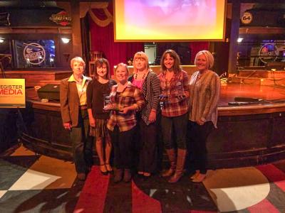 Angela Harrington (second from the left), Emily Counts (third from the left) and Rachel Kinnick (fifth from the left), employees of the Chamber, pose  with their awards. Photo contributed. 