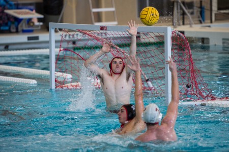 Zach Laird ’17 attempts to block an opponent’s shot. Photo by John Brady. 