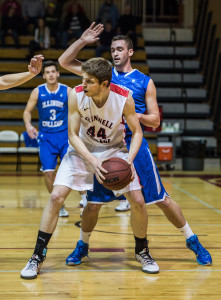 Tague Zachary '15 fends off Illinois College.  Photo Credit John Brady 