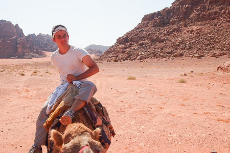 Sam Curry ’16 sits atop a camel in Amman, Jordan during his study abroad program last fall. Photo contributed