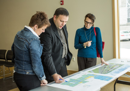 Members of the  School District and the School Board look over and discuss new layouts for the Grinnell-Newberg High School and Middle School, highlighting the changes. Photo by Jenny Chi.