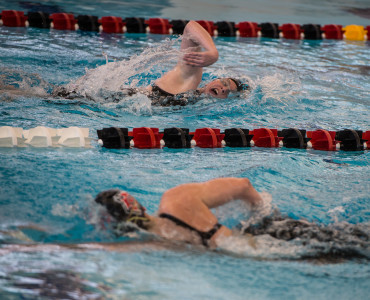 John Brady   Beth Gillig ’15 and Meagan McKinstry ’16 swimming in the mile at the Last Chance Invite.  Photo by John Brady 