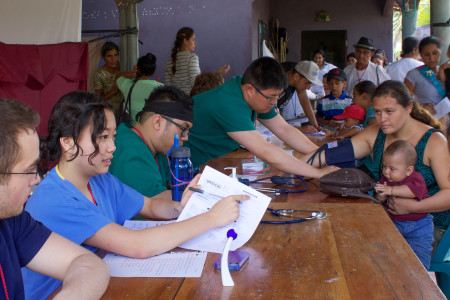 Left to right: Ryan Yellot, Jamie Schafroth, Jarren Santos and Richard Lee (all ’17) interact with patients at a clinic in Nicaragua during their Global Brigades trip over spring break. Photo contributed