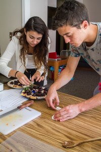 Anastasiia Morozova’18 and Kevin Connors ’18 put finishing touches on the baguettes. (Photo by Misha Gelnarova)