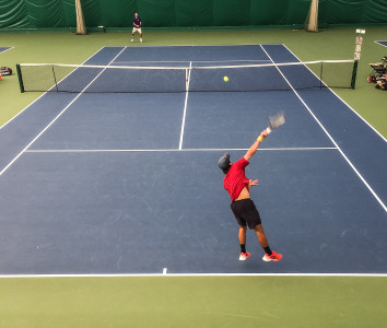 Cole Miller ’17 serving in the third-round match he won.  Photo by Sam Catanzaro