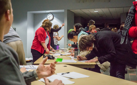 Volunteers register students to vote in the Democratic Iowa Caucus at the Harris Center precinct. Photo by Sydney Steinle 