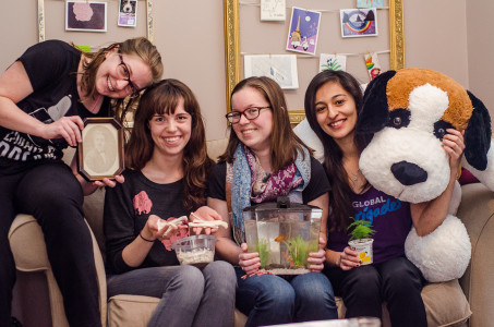  The four women of 1027 Elm St. show off different artifacts from their newly renovated home, from cat bones to a big stuffed dog.  Photo by Ellen Schoenmaker.