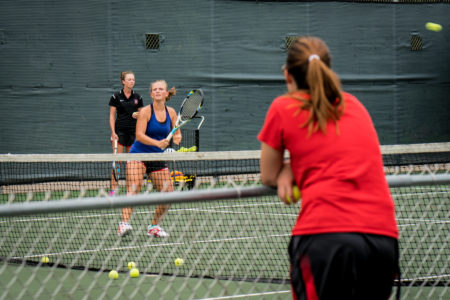 The women's tennis team practices on Wednesday before their next match against the University of Wisconsin-Whitewater. Photo by Xiaoxuan Yang.