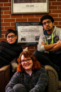 Magyar '17, Lily Galloway '17 and Takshil Sachdev '19 pose in front of the front page of The S&B from 30 years ago when the SRC was started. Photo by Jenny Dong. 