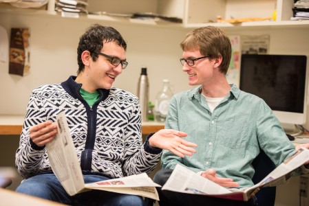Nathan Forman ’15 and Joe Wlos ’15 browse their preferred news source, The Scarlet and Black. Photo by John Brady.