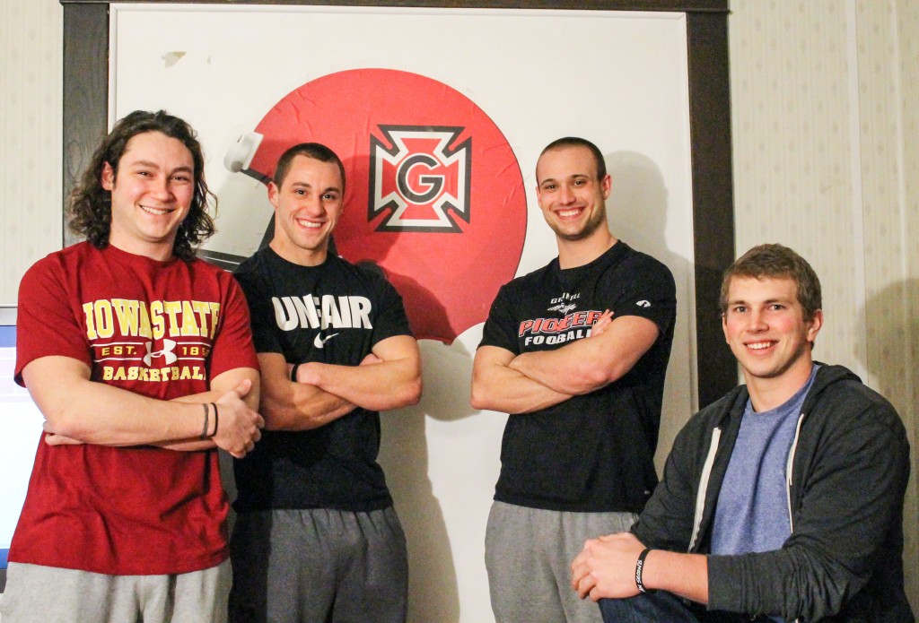 Max Keller, Seth Gustafson, Andrew Clark and Morgan Kinsinger (’14) pose with their guns. Photo by Tela Ebersole.