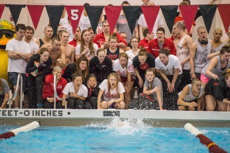 The women’s and men’s swimming and diving teams cheer during last weekend’s conference meet. Photograph by John Brady.